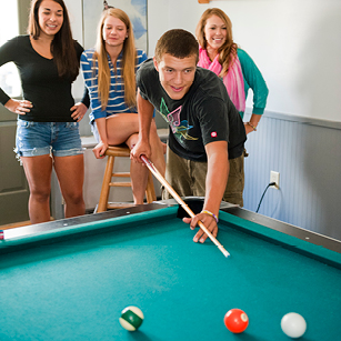 Teens playing pool at The Alley